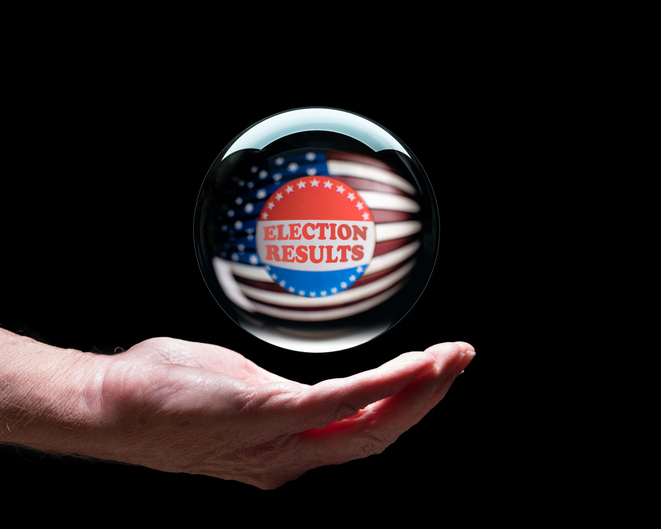 A hand holds an orb with an American flag inside and a sign reading "election results." This post looks at elections and clinical trials. Clinical studies blog.